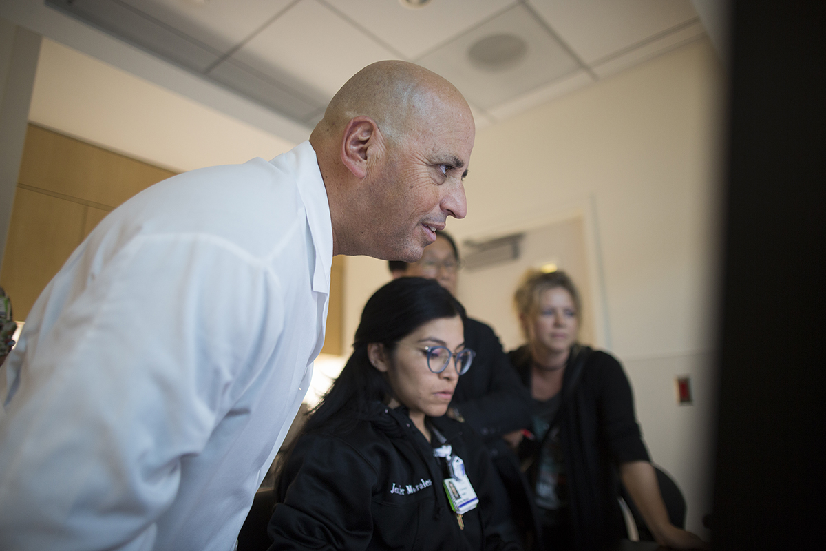 Dr. Robert Klapper, co-director of the Joint Replacement Program, examines results of a CT scan of a saber-toothed cat bone found near the La Brea Tar Pits.