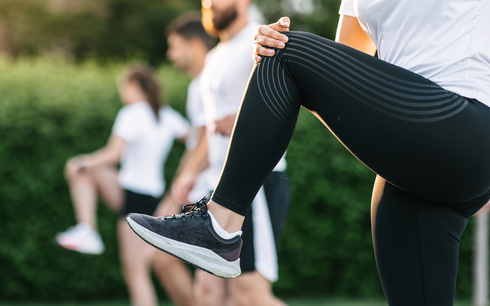 A person holding onto their knee for stretching